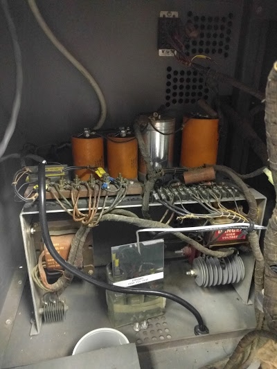 Power supply for the IBM Type 83 card sorter. Filter capacitors are at top. The power transformer is on the left. Selenium rectifiers (left and right) are built from stacks of selenium disks.