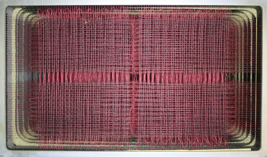 Core memory in the IBM 1401 mainframe. Each layer (plane) has 4,000 tiny cores in an 80x50 grid. Multiple planes are stacked to form the memory.